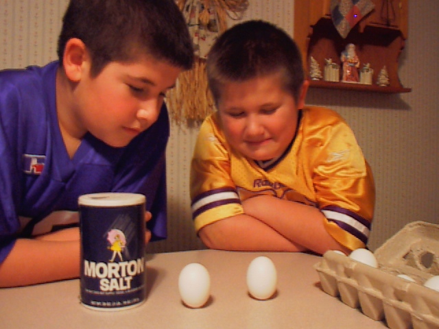 two students "balancing" eggs at equinox.
